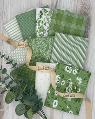 Collection of 10 fat quarters in a fresh spring green and off white with green accents fabrics. An array of florals, stripes and geometrics. 