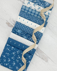 10 fat quarters- 7 bright medium blue with tone on tone florals and plaids. 3 ivory with denim blue accents of stars, dots and florals. 