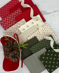 Collection of 12 fat quarters. 4 of each cream, deep red and evergreen, all with a low volume Christmas feel. 