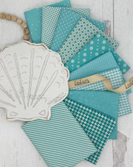 10 aqua and soft teal fat quarters in geometric and gingham prints. 