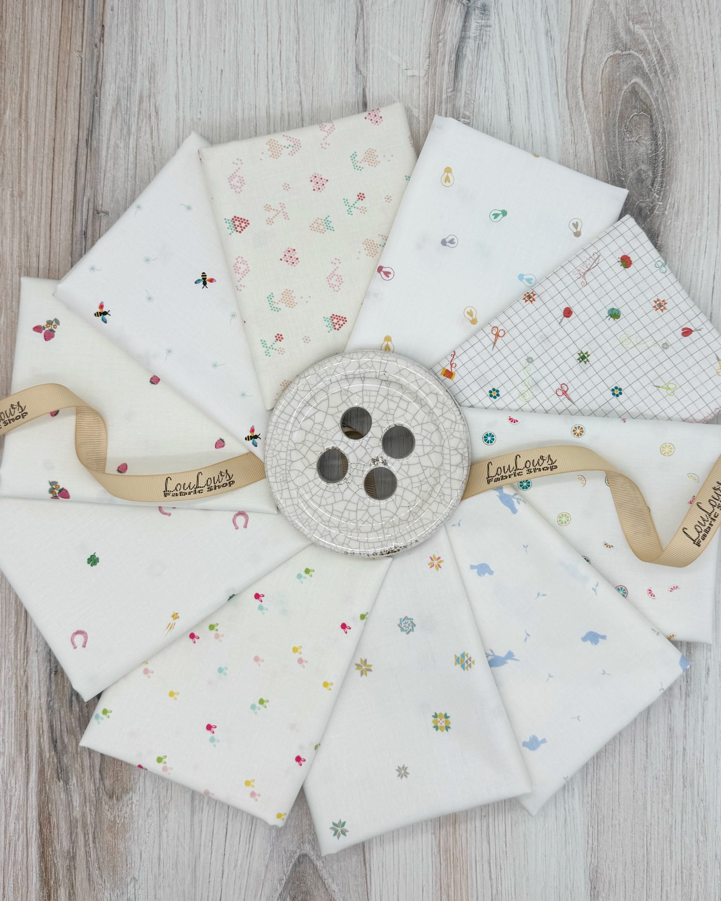 10 fat quarters in low volume spring prints on an off white background. 