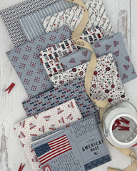 Collection of 10 fat quarters with soft blue and off white backgrounds. All with patriotic themes. 