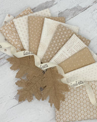 10 fat quarters with cream or tan backgrounds with a variety of floral, dot and geometric prints. 