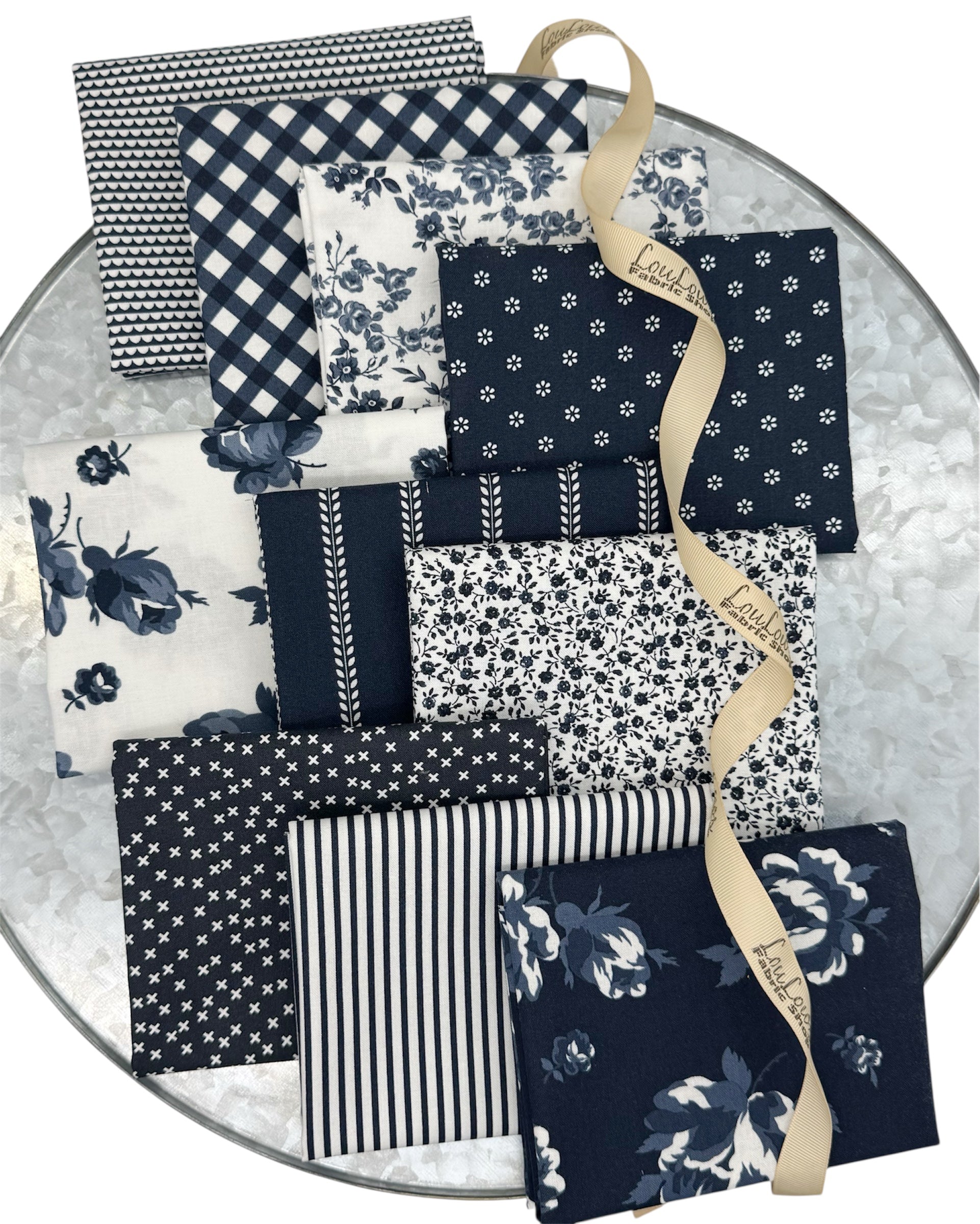 10 fat quarters in dark midnight navys and creamy whites. Florals, stripes and geometrics. 